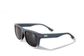 Side view of Gnar Optics Vandals sunglasses with grey rectangular frames, dark grey polarized lenses and a white Gnar logo on the arm