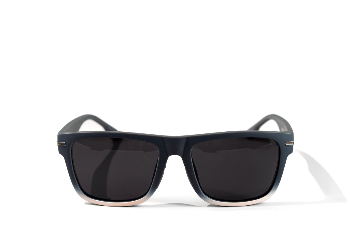 Front view of Gnar Optics Vandal sunglasses with the bold grey/white rectangular frames, dark grey polarized lenses and Gnar logo on arm.