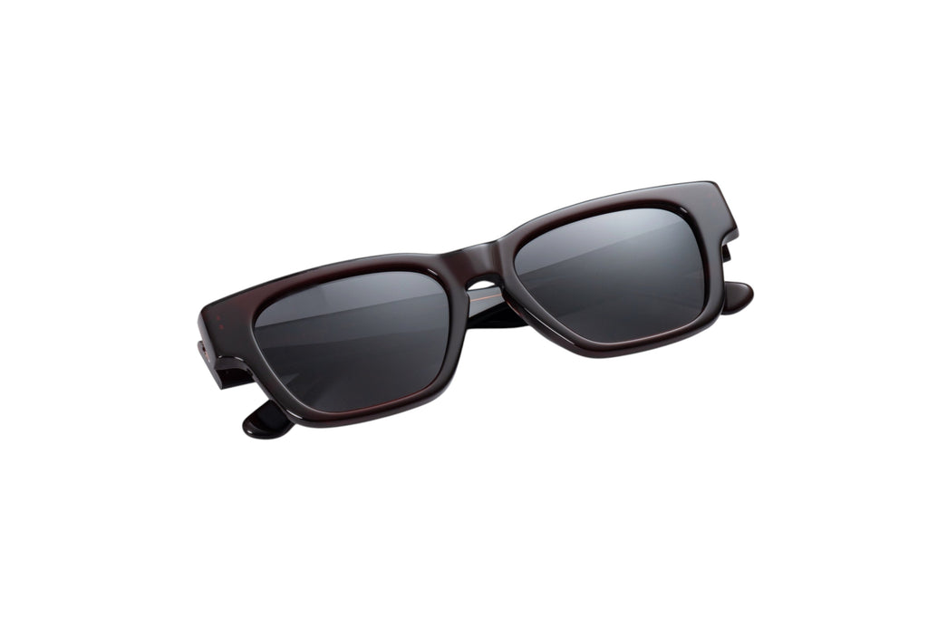 Close up front view of Gnar Optics disaster sunglasses with a dark acetate burgundy frame, rectangular shape and dark grey polarized lenses