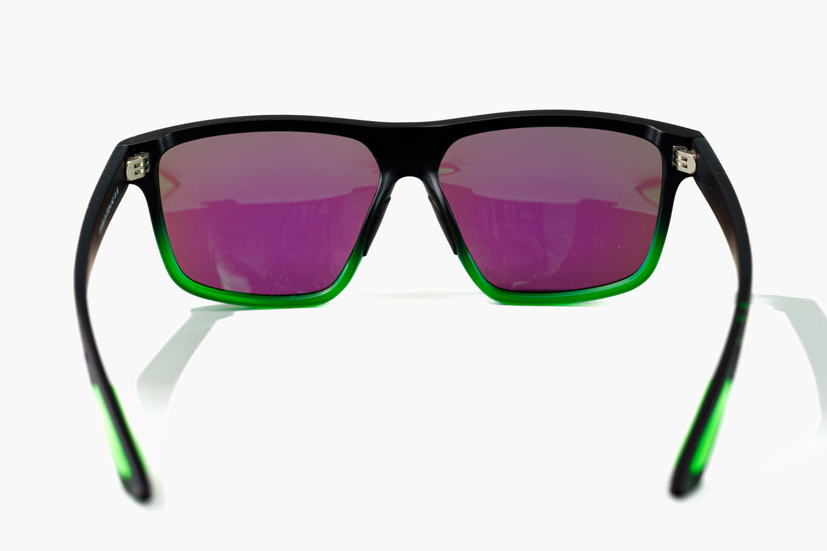 Rear view of GNAR Optics Krook sunglasses showing the black and green rectangular frame, mirrored polarized lenses, metal 5 gauge hinges and green grip accents on arms.