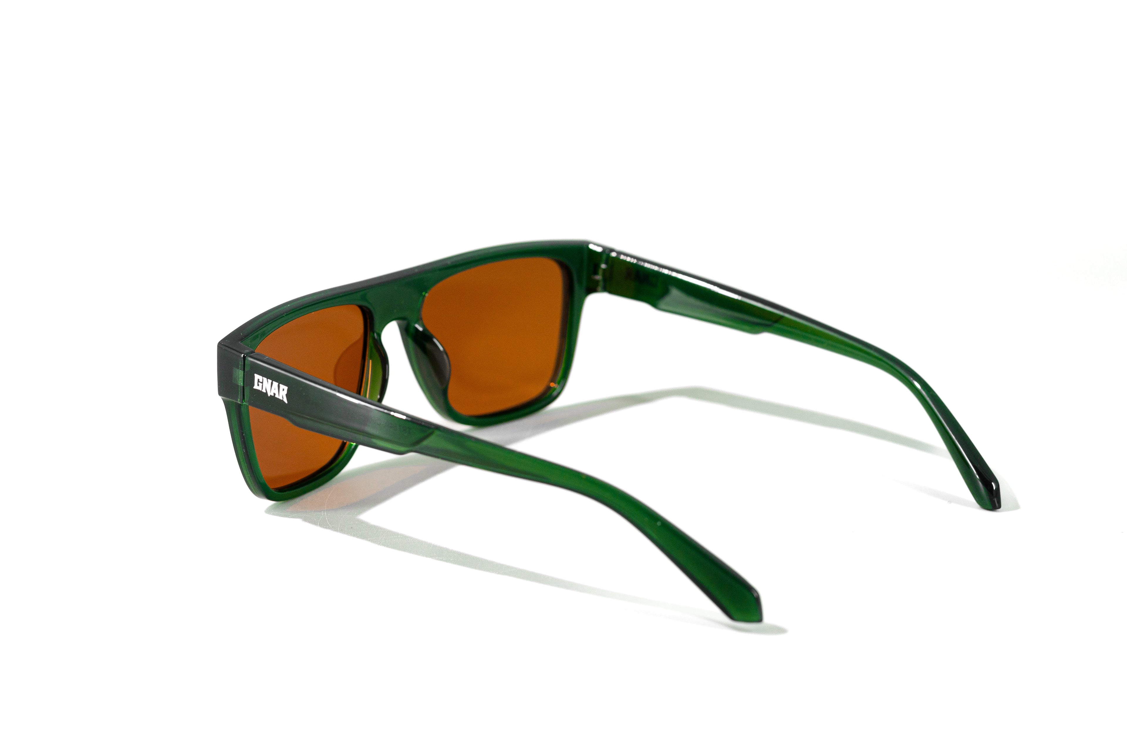 Green sunglasses with brown lenses on a white background