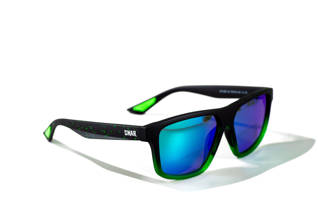 Sunglasses with green and black frame and blue lenses on a white background