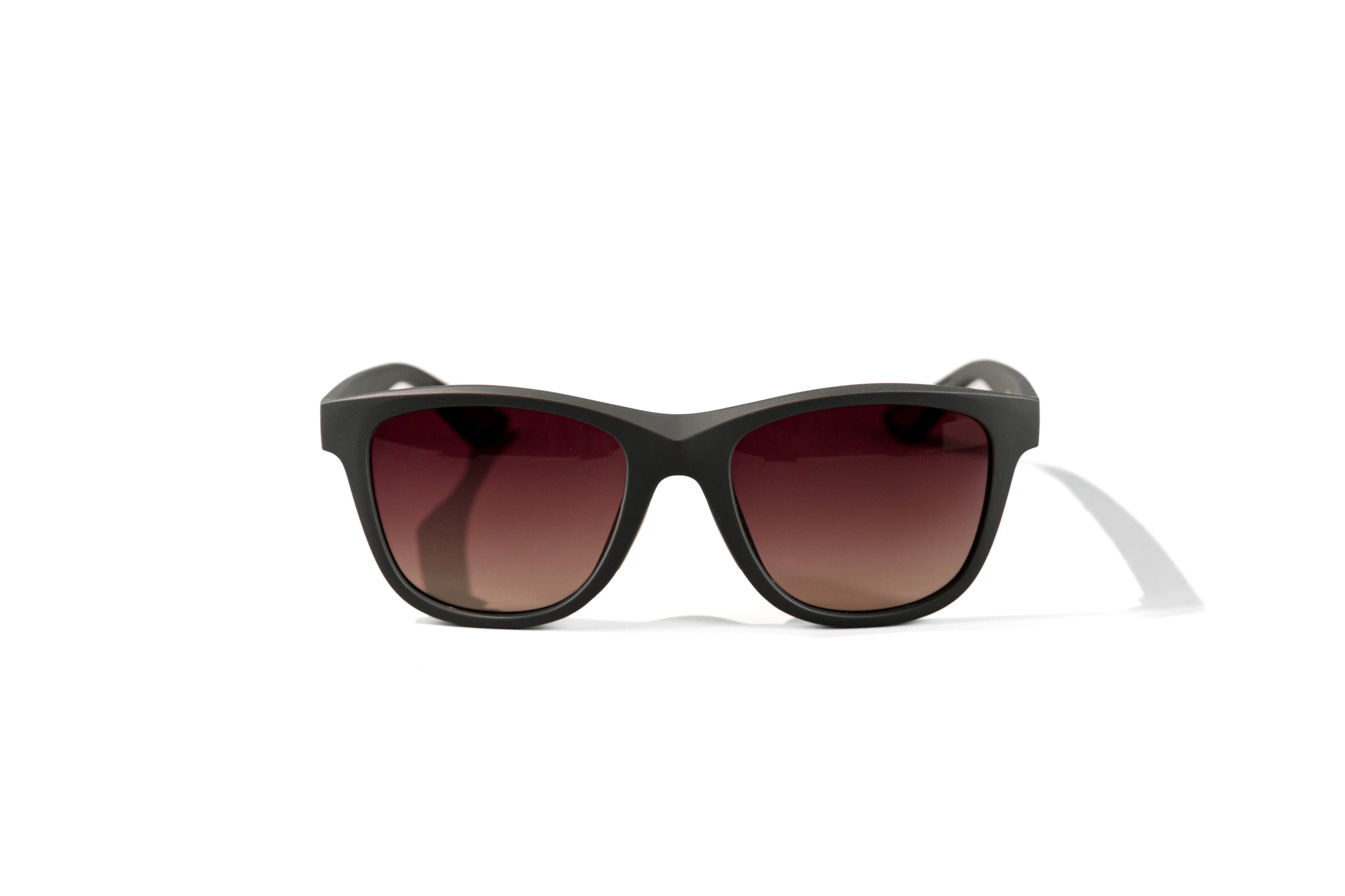 Black sunglasses with brown lenses on a white background